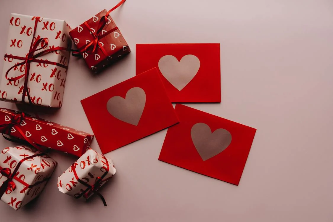 Tarjetas y regalos decorados con motivo de San Valentín, en tonos rojos y corazones